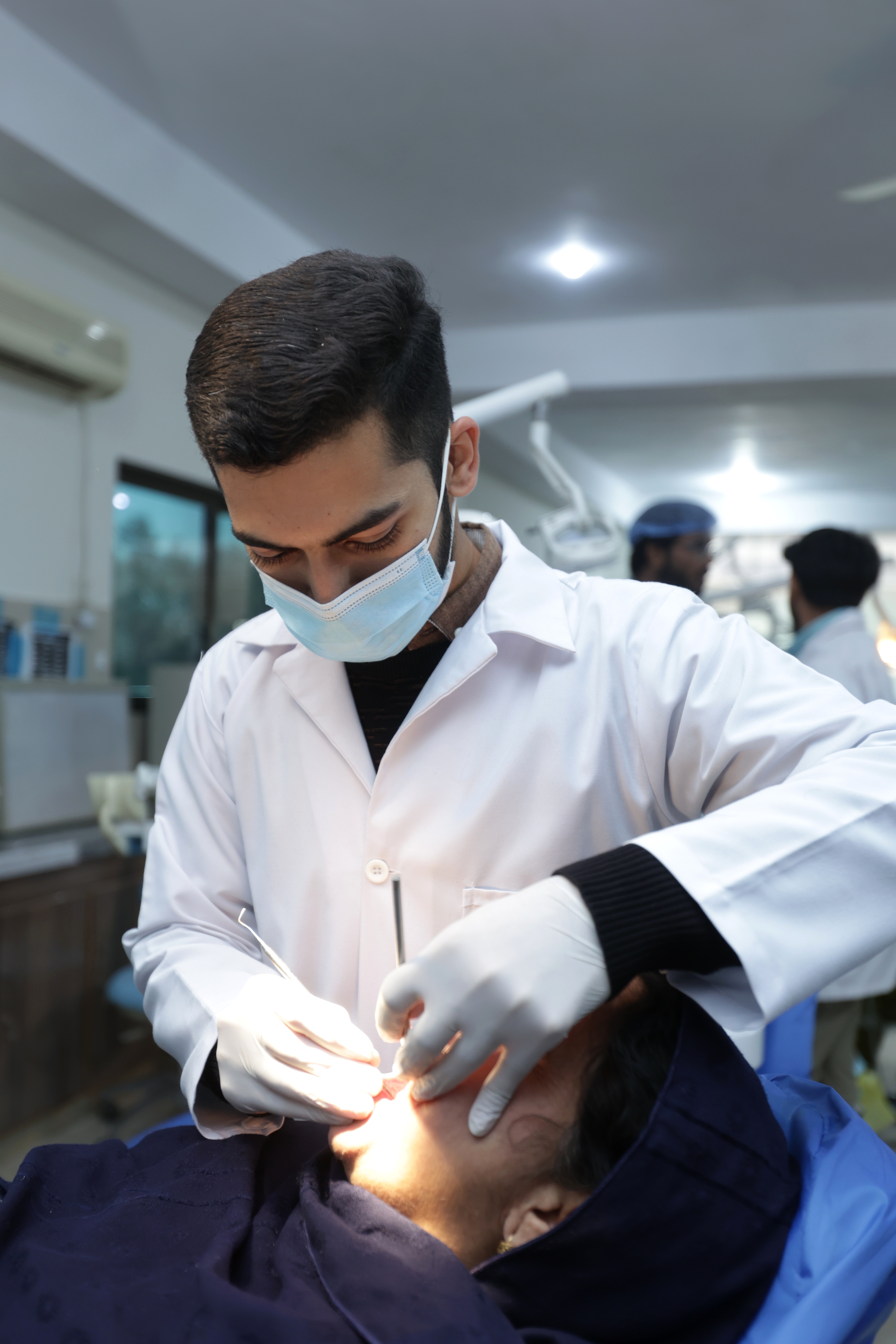 Dr. Syed Hammad Hussain Shah providing dental treatment at Dental Consultants, Gujrat
